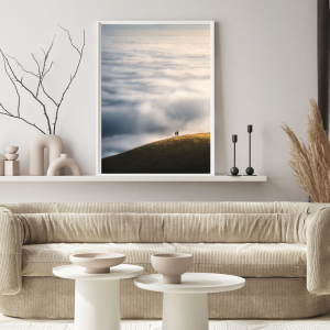 Photograph of a couple standing on a hilltop above a California low fog during sunrise